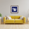 A framed white papercut of two cranes at the shore with Ani L’Dodi V’Dodi Li in Hebrew between them, matted on a rich blue mat. 